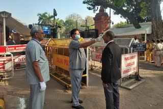 Tharmometer gun on the forehead of employees in the Parliament Gate