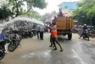 government staffs disinfectant spraying to people