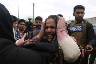 Family members cry after an attack in Kabul, Afghanistan