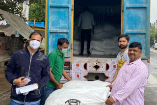 bjp mla om prakash sharma distributing flour sack to needy at anand vihar slums in delhi