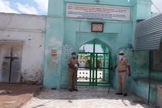 Policemen at the mosque's gate