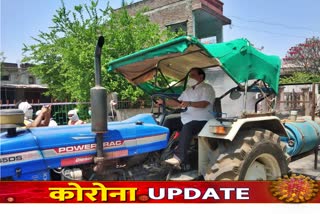 eknath-khadse-driving-a-tractor-sprayed-in-the-village-in-jalgaon