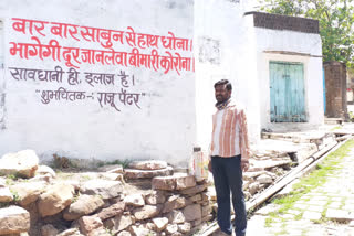 painter is writing slogan outside the house in Vidisha