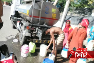 People taking water from Delhi Jal Board tanker as crowd in Shastri Park Delhi lockdown