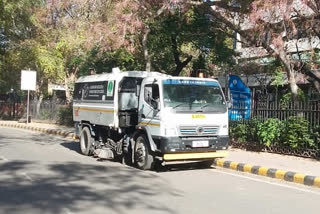 ndmc using mechanical sweeper for road sanitation during corona lockdown in new delhi