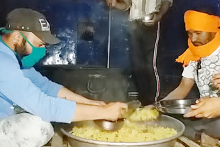 The Ready to Help team distributes free food to poor villagers late in the evening.