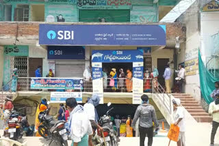 people waiting in front of  banks at vardhannapeta warangal