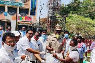 distribution of daily essentials to the poor municipal workers by the electric employees in palvancha bhadradri kothagudem