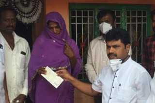 Distribution of compensation checks to the farmer's family