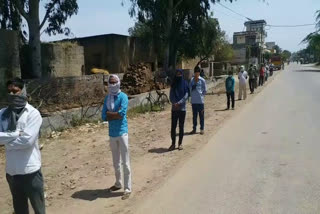 people waiting in line for food in gohana