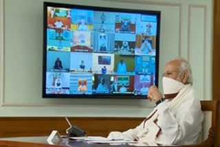 narendramodi wears a homemade face cover video-conferencing over COVID-19.