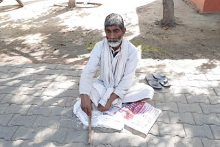 Worker sitting on the street begging due to lack of employment