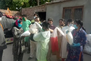 people of social institutions distribute ration to needy of slum colony in rohini in delhi