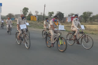 Policemen organize a corona awareness rally in Narsinghgarh