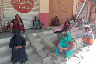 Women wait for hours outside the kiosk center