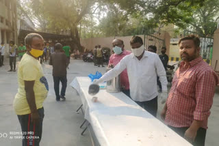 trs leaders distributing ragi java to migrant workers