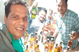 Madhya Pradesh officials suspended for pic with liquor bottles