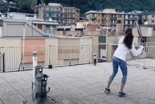 Two Italy women play rooftop tennis during Italy's strict coronavirus lockdown