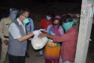 collector distributed ration materials to the needy families.