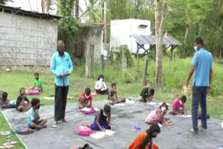 Teacher teaching children in nalbari