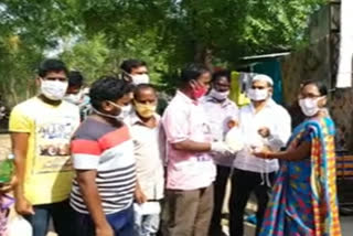 Young people distributing essential commodities to the poor in Warangal