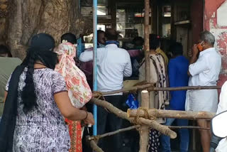 Long line in Liquor shops at Bellary: people dancing with liquor