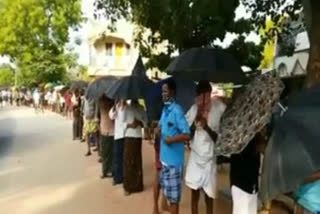 umbrella compulsory for liquor purchase at dharmavaram in ananthapuram district