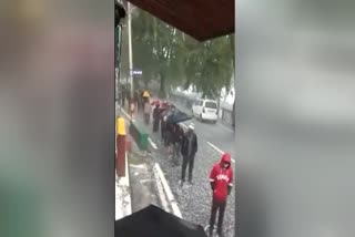 Shoppers brave hailstorm to buy liquor at a shop on Mall Road in Nainital today