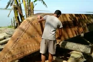 river people in assam preparing boat to fight against flood