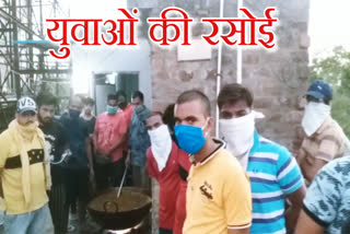 young men providing food to workers