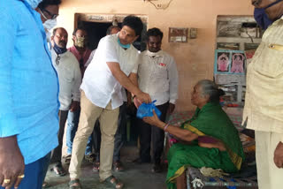 karanam venkatesth giving essentials to poor people on behalf of ycp leaders in chirala