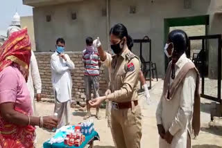 SI and Aanganwari workers distribute masks and sanitizers to villagers in Fazilka