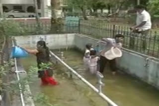 nizamabad collector family participates in cleaning of water fountain