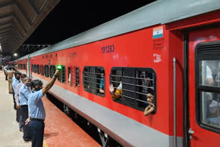 Railway guard showing green signal to a special train in Mumbai