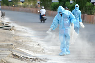 Sanitary workers spraying bleaching powder