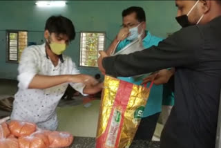 MLA Rupak Sarma Distribution food item to barber and Sound Artist