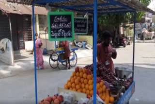 a frutis seller wrote on a slate to create awareness on corona at the same time about his bussiness selling