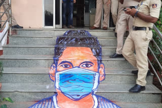 Badal Nanjundaswamy portraying a 3D mask on the police station staircase