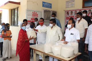 Distributing food grains to poor people through food centers in Sangareddy