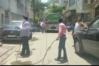 residents sanitizing with edmc workers