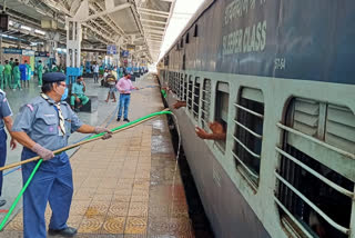 Scout guide's team serving water to passengers of shramik express in itarsi of hoshangabad