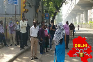 people wait for dtc buses in delhi amid lockdown 4