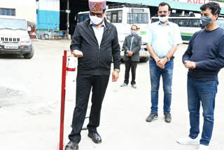 Govind Singh Thakur sanitizing hands with hands free sanitizer