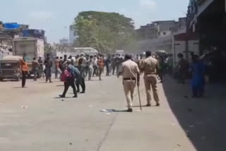 migrants gather at Bandra railway station after rumours of special trains