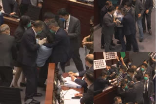 Hong Kong opposition legislators demonstrating in the Legislative Council, scuffle breaks out and two legislators are dragged away