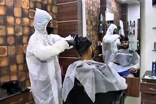 Barber cuts hair by wearing PPE kit