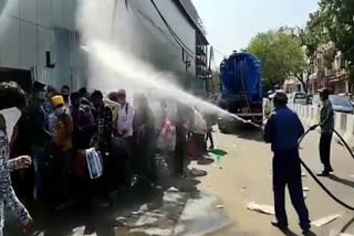 MCD workers spray insecticide on migrant laborers in delhi video viral