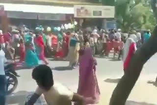 villagers carrying cow carcass