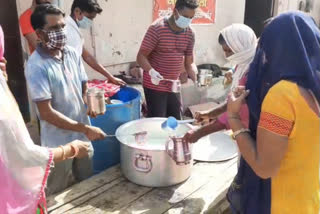 rss Seva Bharati distributing milk to children of 500 poor families in Bhati Mines