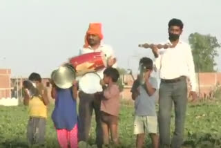 Locals bang utensils, drums to keep locusts away from agricultural field